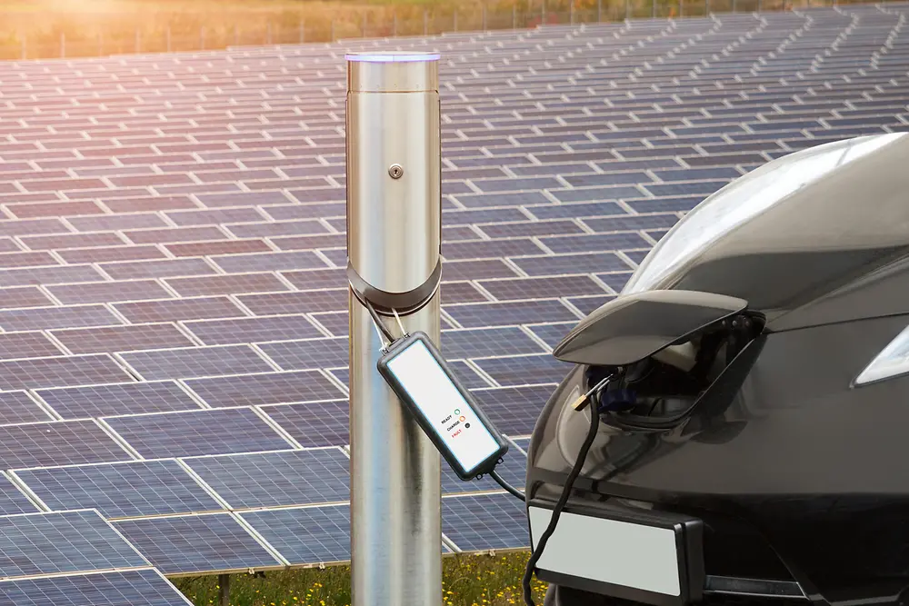 Electric car in front of a solar panel field