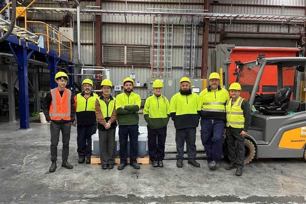 Photograph of a group of people at a production site.